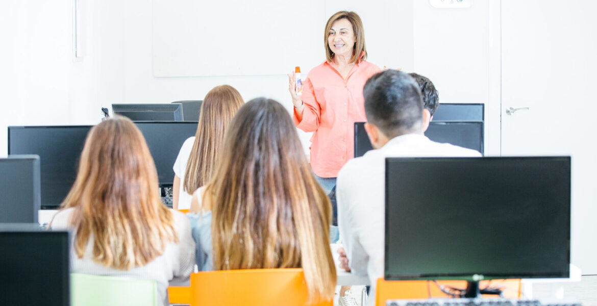 Cheerful tutor teaching students