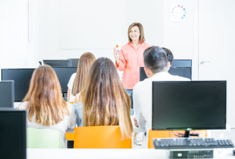 Cheerful tutor teaching students